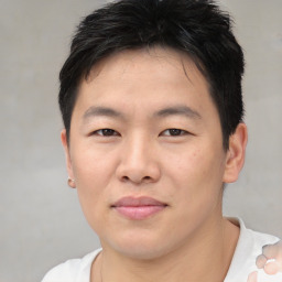 Joyful asian young-adult male with short  black hair and brown eyes