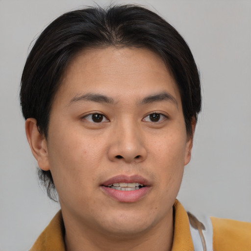 Joyful asian young-adult male with medium  brown hair and brown eyes