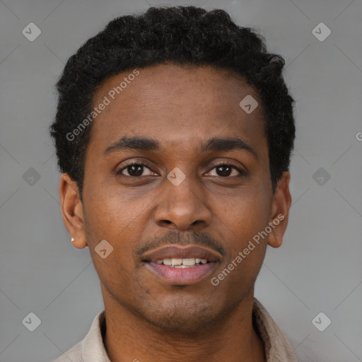 Joyful black young-adult male with short  brown hair and brown eyes