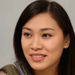 Joyful asian young-adult female with long  brown hair and brown eyes