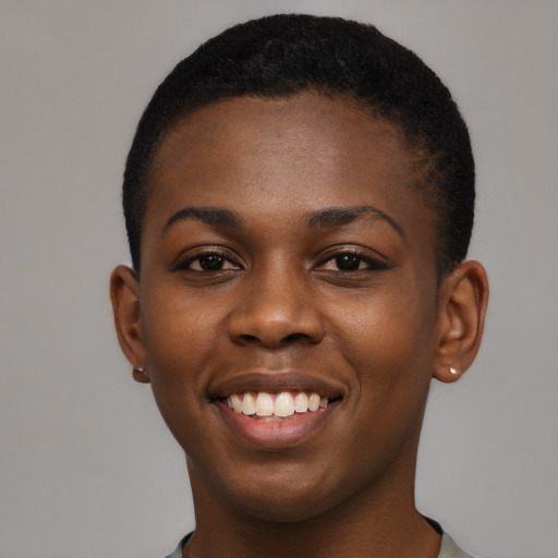 Joyful black young-adult female with short  black hair and brown eyes