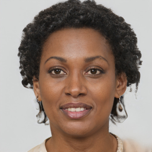 Joyful black adult female with short  brown hair and brown eyes