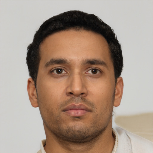 Neutral latino young-adult male with short  black hair and brown eyes
