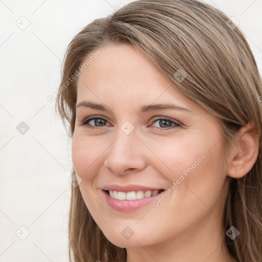 Joyful white young-adult female with long  brown hair and grey eyes