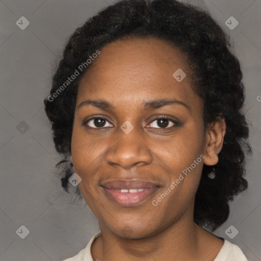 Joyful black young-adult female with long  black hair and brown eyes