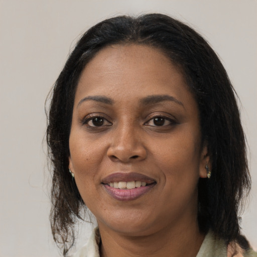 Joyful black adult female with medium  brown hair and brown eyes