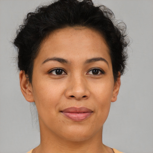 Joyful latino young-adult female with short  brown hair and brown eyes