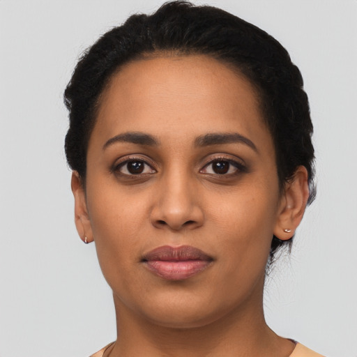 Joyful latino young-adult female with short  black hair and brown eyes
