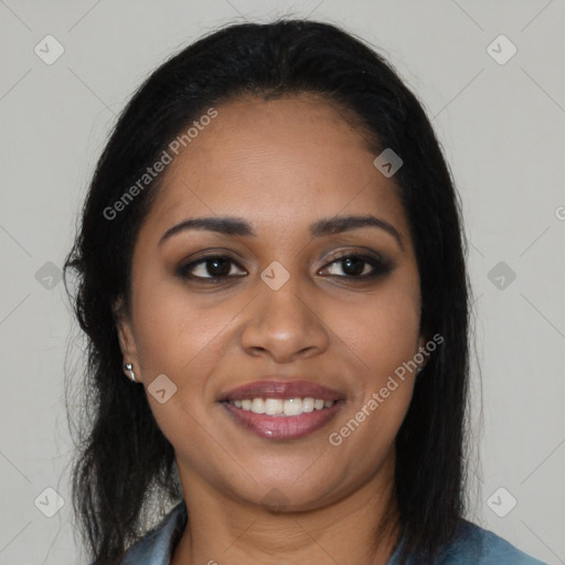 Joyful black young-adult female with long  brown hair and brown eyes