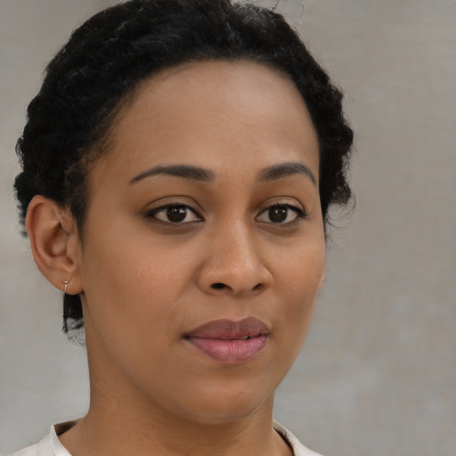 Joyful black young-adult female with short  brown hair and brown eyes