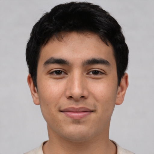 Joyful white young-adult male with short  black hair and brown eyes