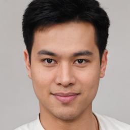 Joyful asian young-adult male with short  black hair and brown eyes