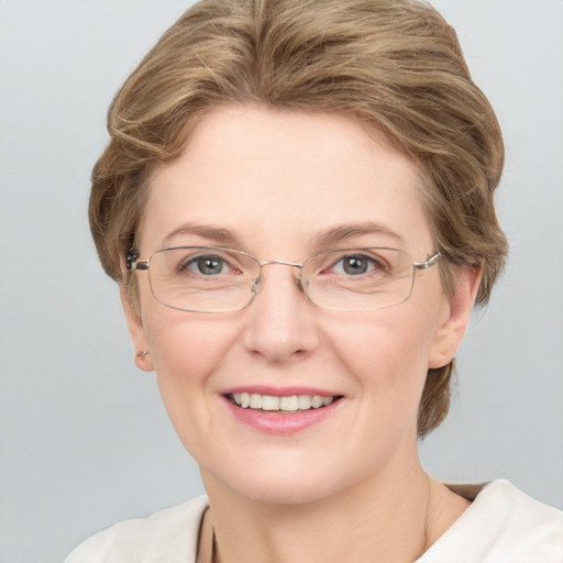 Joyful white adult female with short  brown hair and grey eyes