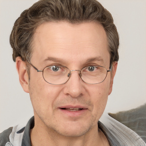 Joyful white middle-aged male with short  brown hair and grey eyes