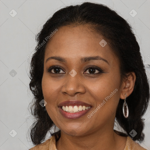 Joyful black young-adult female with long  brown hair and brown eyes