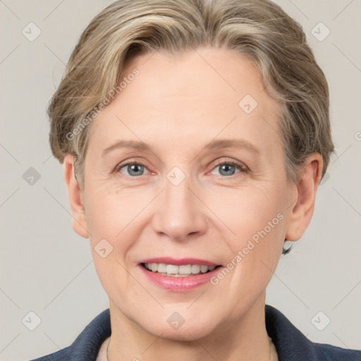 Joyful white adult female with short  brown hair and grey eyes