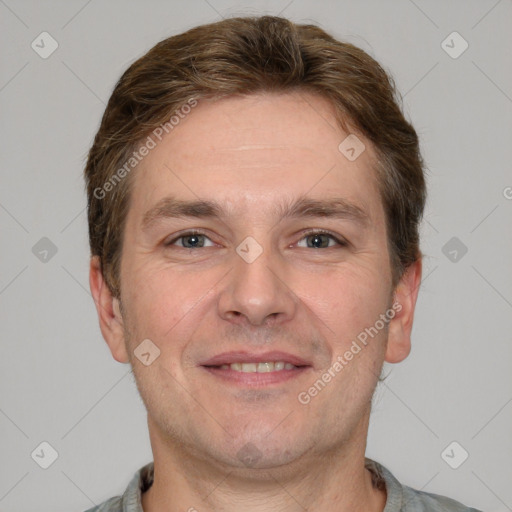 Joyful white adult male with short  brown hair and grey eyes