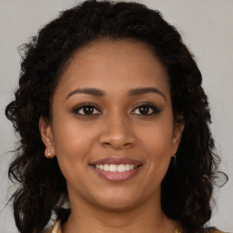 Joyful latino young-adult female with long  brown hair and brown eyes