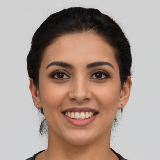 Joyful latino young-adult female with short  brown hair and brown eyes