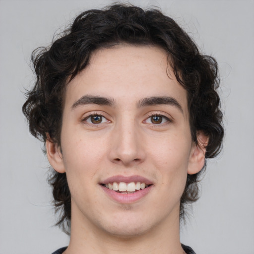 Joyful white young-adult male with medium  brown hair and brown eyes