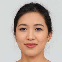 Joyful asian young-adult female with medium  brown hair and brown eyes