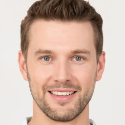 Joyful white young-adult male with short  brown hair and grey eyes