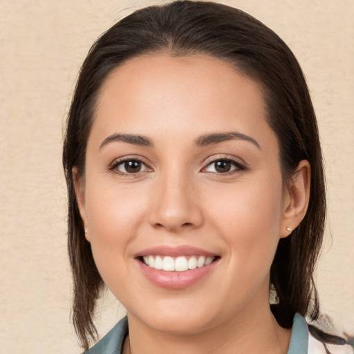 Joyful white young-adult female with medium  brown hair and brown eyes