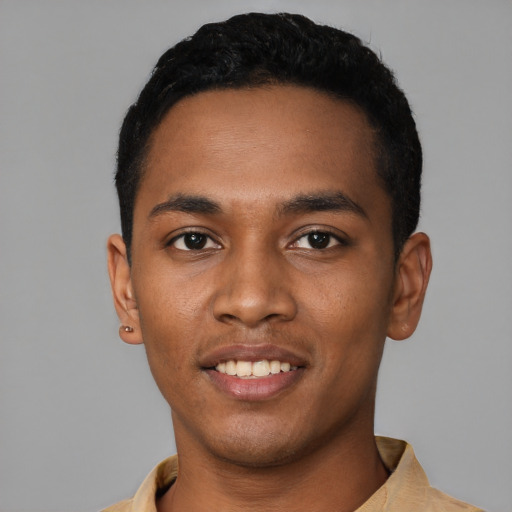 Joyful black young-adult male with short  black hair and brown eyes