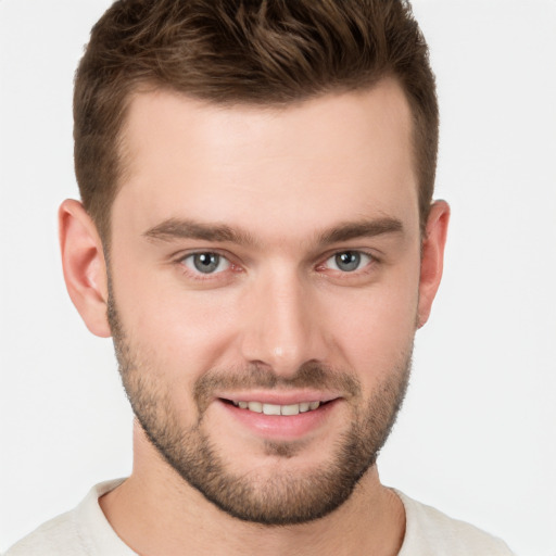 Joyful white young-adult male with short  brown hair and grey eyes