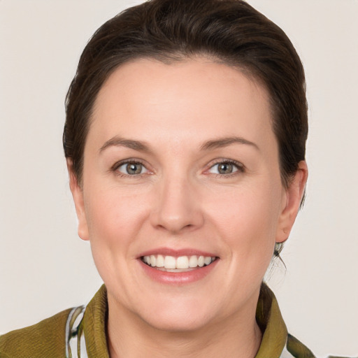 Joyful white young-adult female with short  brown hair and grey eyes