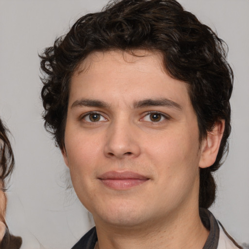 Joyful white young-adult male with medium  brown hair and brown eyes