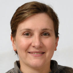 Joyful white adult female with medium  brown hair and grey eyes