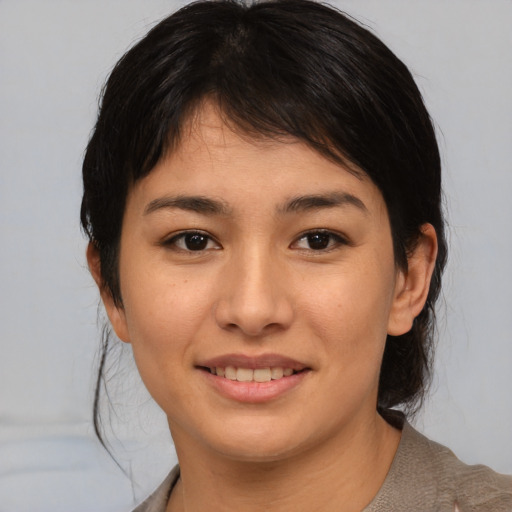 Joyful asian young-adult female with medium  brown hair and brown eyes