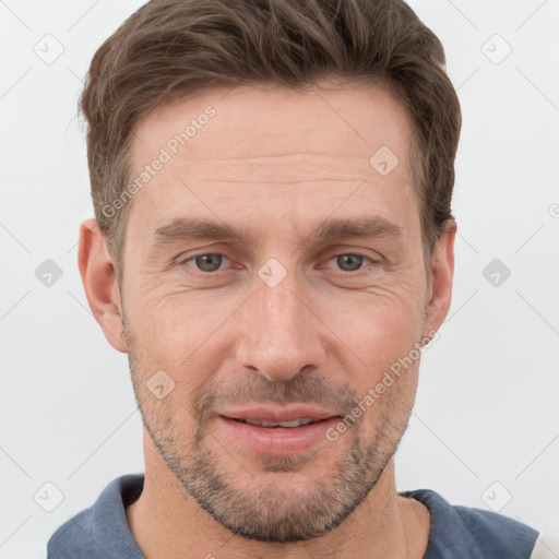 Joyful white adult male with short  brown hair and grey eyes