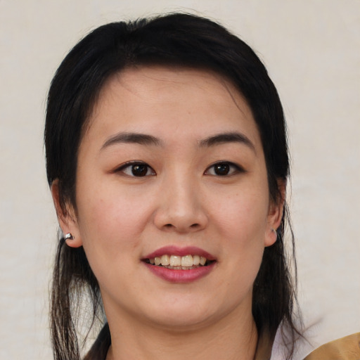 Joyful asian young-adult female with medium  brown hair and brown eyes