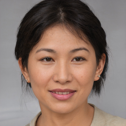 Joyful asian young-adult female with medium  brown hair and brown eyes