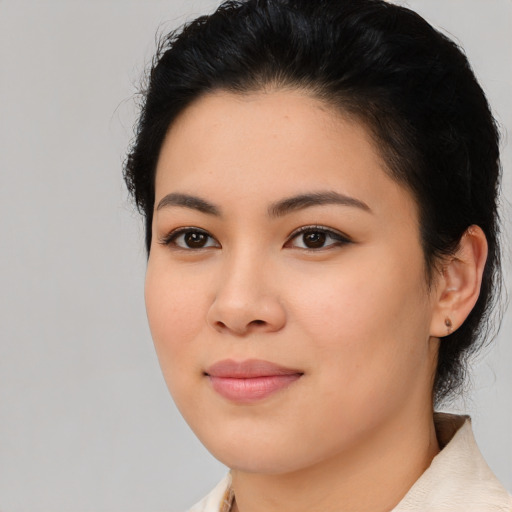 Joyful white young-adult female with medium  black hair and brown eyes