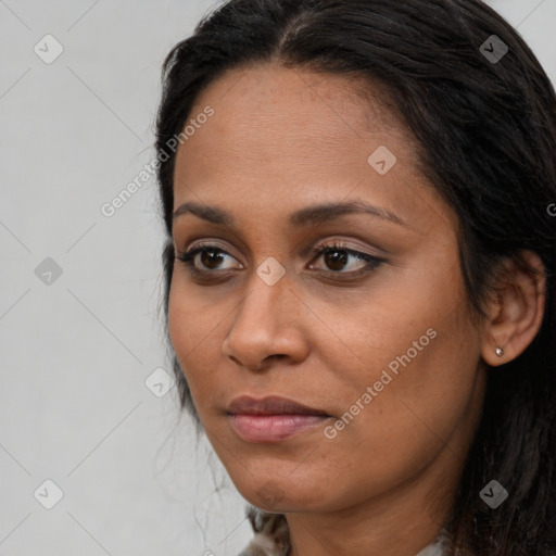 Joyful latino young-adult female with long  brown hair and brown eyes