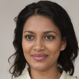 Joyful black young-adult female with medium  brown hair and brown eyes