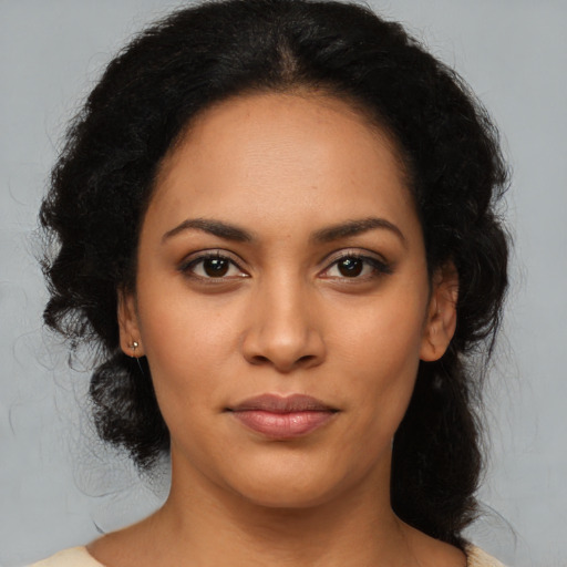 Joyful latino young-adult female with medium  black hair and brown eyes