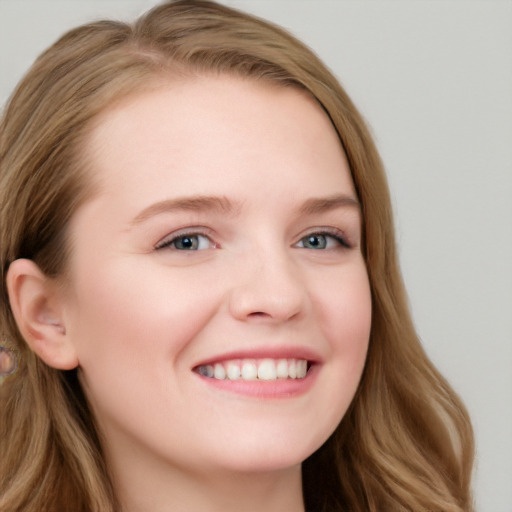 Joyful white young-adult female with long  brown hair and blue eyes