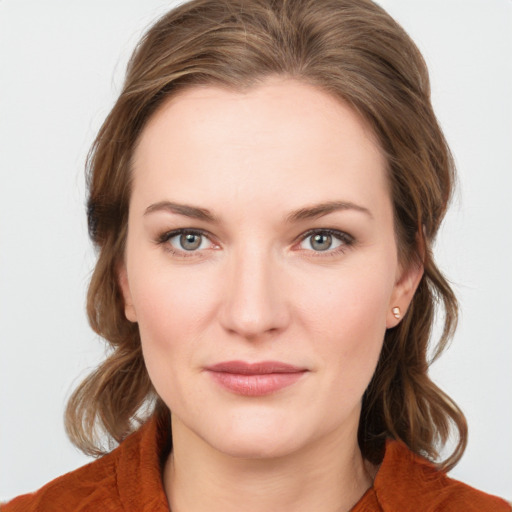 Joyful white young-adult female with medium  brown hair and blue eyes