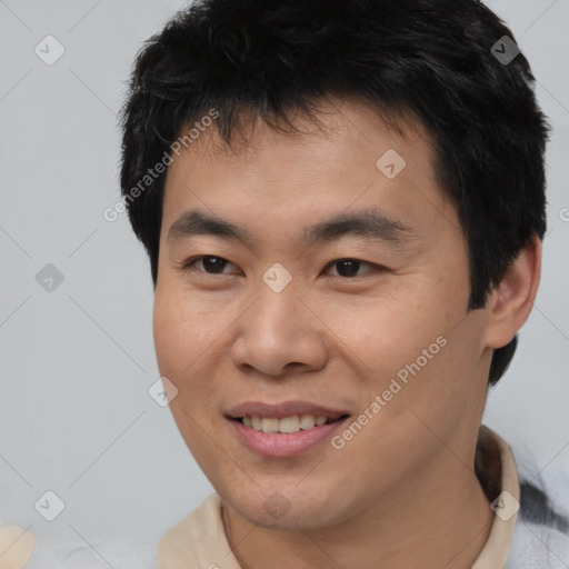 Joyful asian young-adult male with short  brown hair and brown eyes