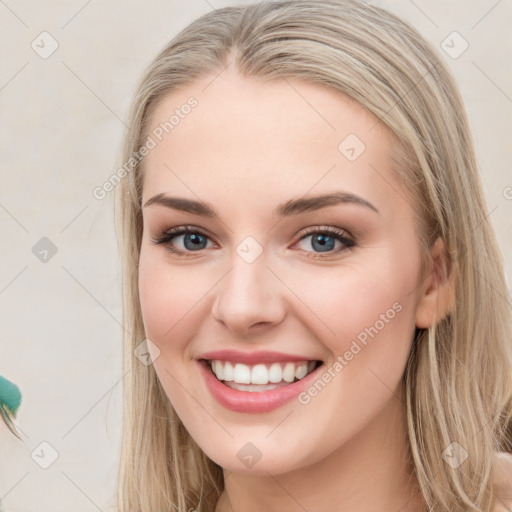 Joyful white young-adult female with long  brown hair and green eyes