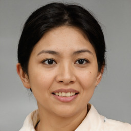 Joyful asian young-adult female with short  brown hair and brown eyes