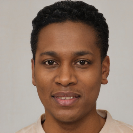 Joyful black young-adult male with short  black hair and brown eyes