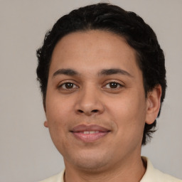 Joyful latino young-adult male with short  brown hair and brown eyes