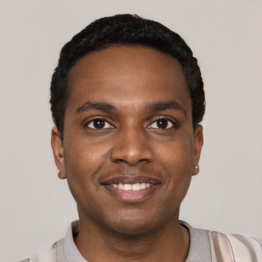Joyful black young-adult male with short  black hair and brown eyes