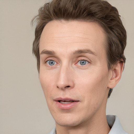 Joyful white adult male with short  brown hair and grey eyes