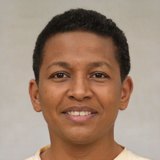 Joyful latino young-adult male with short  brown hair and brown eyes